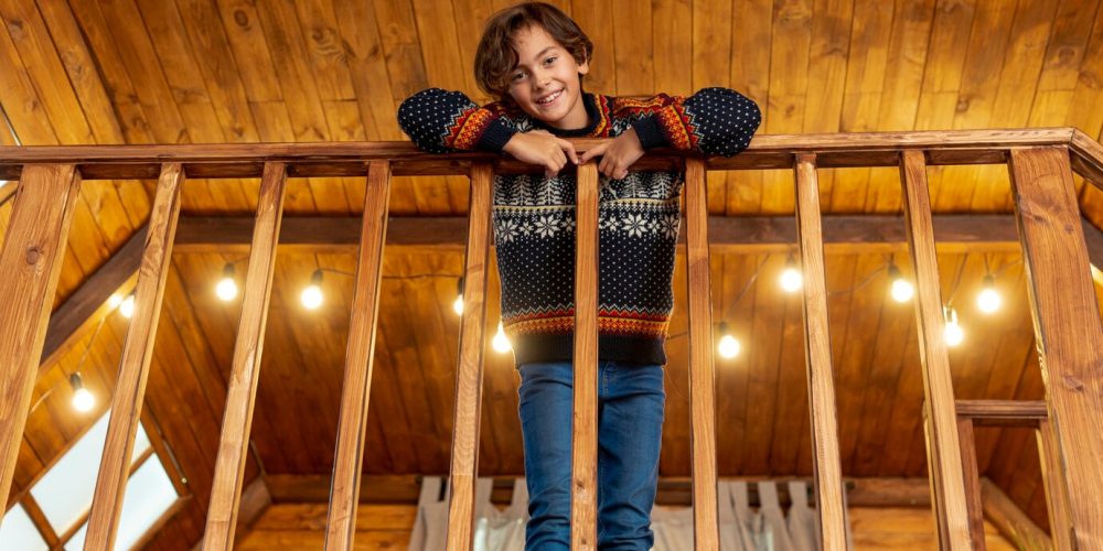 low-angle-happy-kid-posing-near-balustrade_23-2148321761